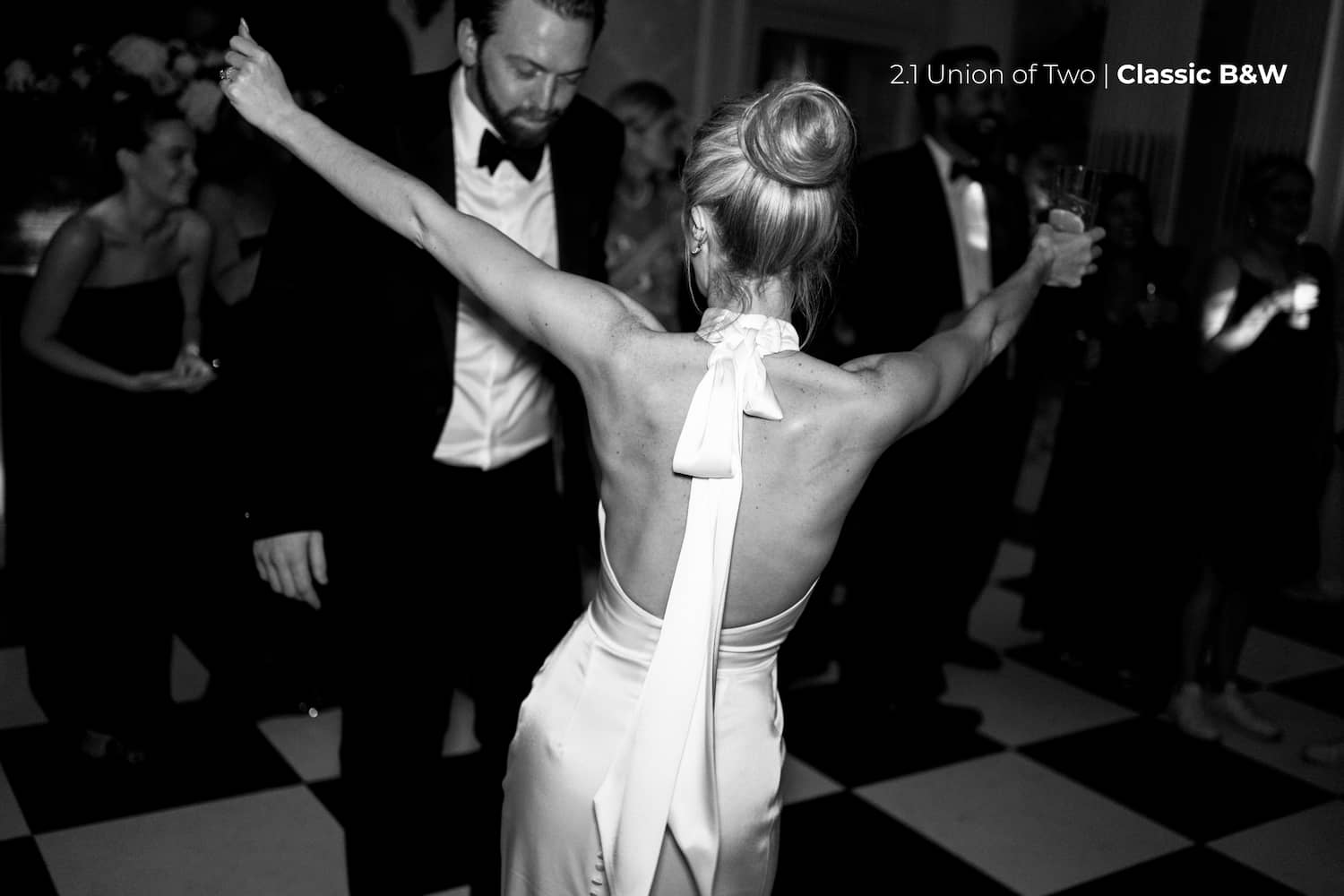 A bride and groom during their first dance with a check board floor,  edited with Union of Two 2.0 Preset Pack.