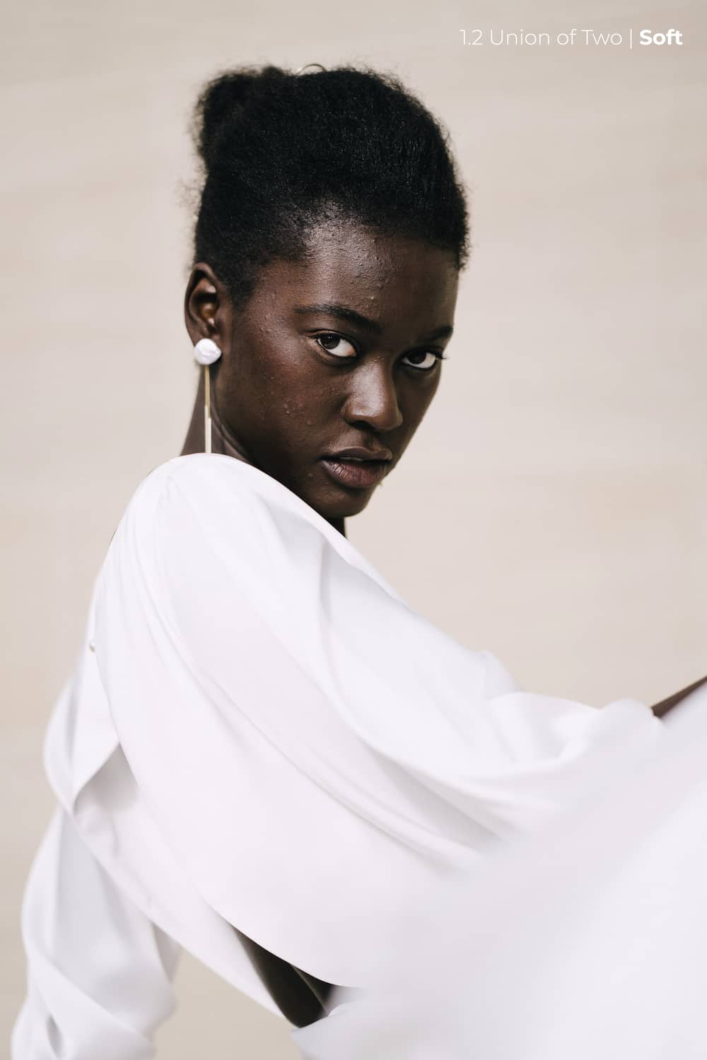 A model is wearing a white wedding dress with a statement earring visible, edited with the Union of Two 2.0 Preset Pack.